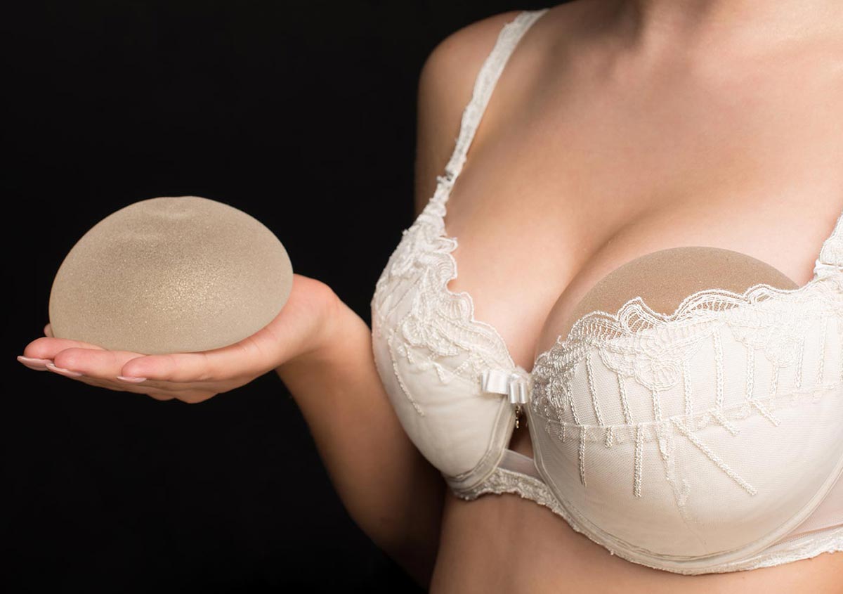 Silicone implants on hand and natural breast