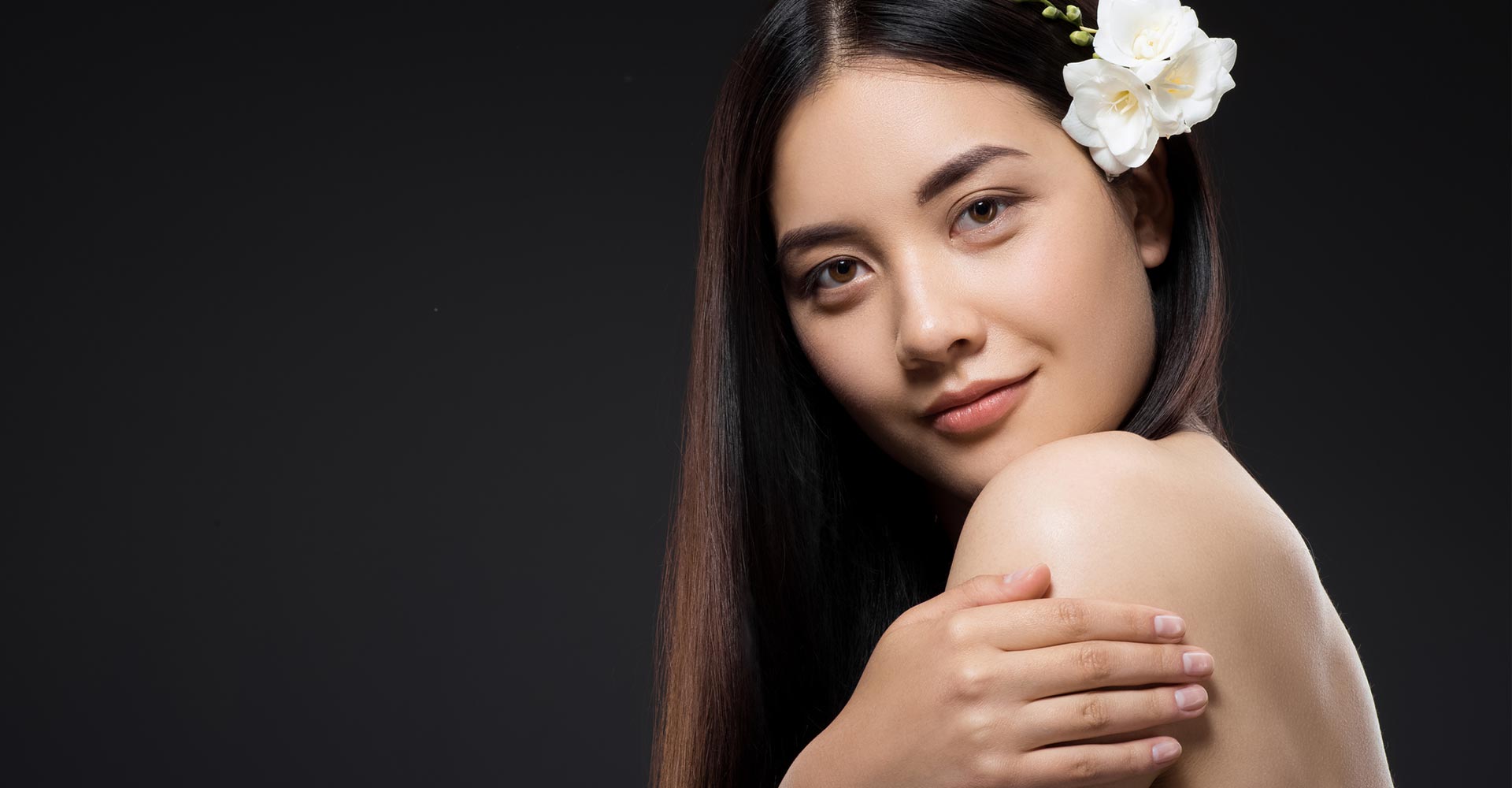 Portrait of beautiful young asian woman with white flowers in hair